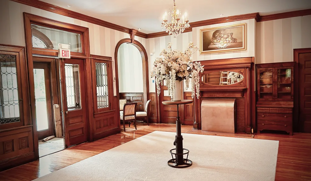 Idylease arrival lobby with staircase and polished woodwork